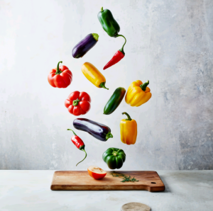 Vegetables Flying Off the Cutting Board